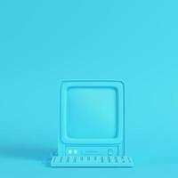 Retro computer on bright blue background in pastel colors photo