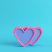 Two abstract pink hearts on bright blue background in pastel colors. photo