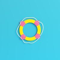 Yellow life buoy on bright blue background in pastel colors. Minimalism concept photo