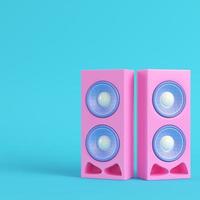 Pink stereo speakers on bright blue background in pastel colors photo