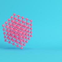 Abstract pink spheres in wire box on bright blue background in pastel colors photo