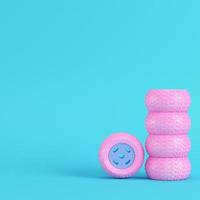 Pink car wheels on bright blue background in pastel colors. Minimalism concept photo