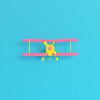 Yellow biplane on bright blue background in pastel colors. Minimalism concept photo