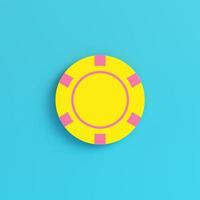 Yellow casino chip on bright blue background in pastel colors photo