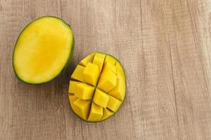Fresh and ripe mango fruit on wooden table. Space for text. Close up. photo