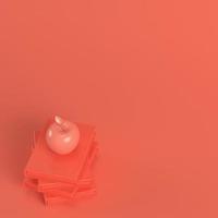 Apple on a stack of books in living coral color. Minimalism concept photo