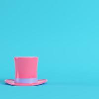 Pink top hat on bright blue background in pastel colors. Minimalism concept photo