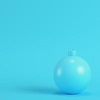 Christmas ball on bright blue background in pastel colors photo