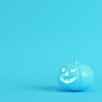 Halloween pumpkin, jack o lantern on bright blue background in pastel colors photo