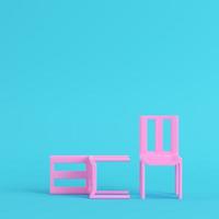 Two pink chairs on bright blue background in pastel colors photo