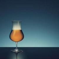 Glass with alcohol on dark background. photo