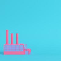 Pink factory on bright blue background in pastel colors photo