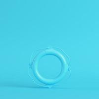 Life buoy on bright blue background in pastel colors. Minimalism concept photo