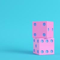 Pink two dices on bright blue background in pastel colors photo