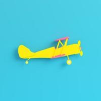 Yellow biplane on bright blue background in pastel colors. Minimalism concept photo