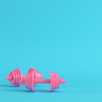 Abstract pink dumbbells bright blue background in pastel colors photo