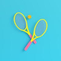 Yellow tennis rackets with ball on bright blue background in pastel colors photo