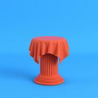 Orange cloth on a pedestal on bright blue background photo