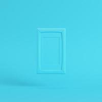 Blank frame on bright blue background in pastel colors photo