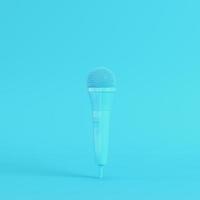 Microphone on bright blue background in pastel colors. Minimalism concept photo