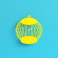 Yellow bird cage on bright blue background in pastel colors photo