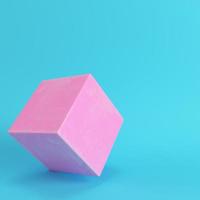 Abstract pink cube with scratches on bright blue background in pastel colors photo