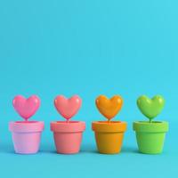 Colorfull hearts in the pots on red box on bright blue background photo