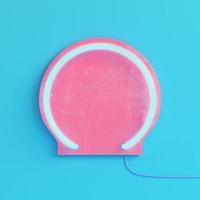 Pink plate with neon light on bright blue background in pastel colors photo