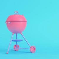 Charcoal kettle barbecue grill on bright blue background in pastel colors. Minimalism concept photo