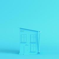 Cartoon styled house on bright blue background in pastel colors photo