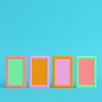 Four colorful blank frames on bright blue background in pastel colors photo