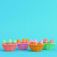 Colorful easter eggs with bow in a wicker basket on bright blue background in pastel colors. Minimalism concept photo