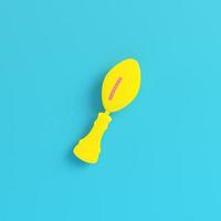 Yellow american football ball throphy on bright blue background in pastel colors photo