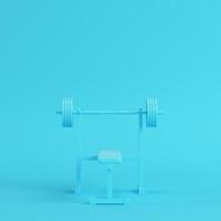 Barbell with bench on bright blue background in pastel colors. Minimalism concept photo