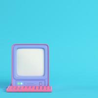 Pink retro computer on bright blue background in pastel colors photo