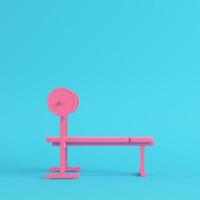 Pink barbell with bench on bright blue background in pastel colors. Minimalism concept photo