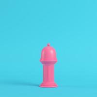 Pink plate with dome on ancient column bright blue background in pastel colors photo