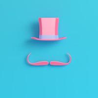 Pink cylinder hat with fake mustache on bright blue background in pastel colors photo