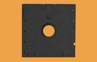 Vintage Floppy Disk 5.25 inch. Retro storage technology isolated on orange background. photo