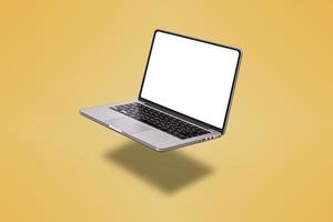 Laptop computer with blank screen isolated on yellow background photo