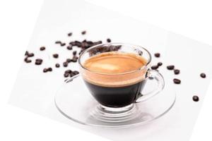 selective focus.Black coffee in clear glass, Transparent coffee cup with roasted coffee beans isolated on a white background with copy space.soft focus. shallow focus effect. photo