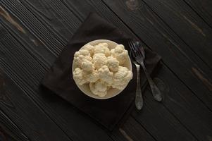 Raw, fresh organic cauliflower on a wooden background. Healthy eating, low carb diet concept photo