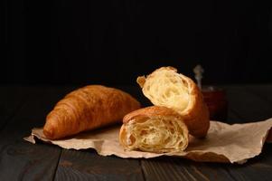 Fresh croissants on a wooden background. photo