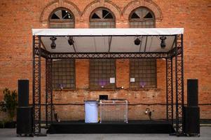 Empty DJ booth against a brick wall. Party at a closed factory photo