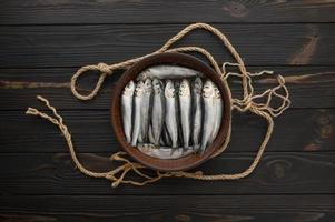 Fresh herring on rustic wooden background, close up shot photo