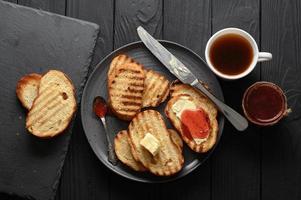 Continental Breakfast meal served with coffee, toast, jam and butter. Delicious coffee table. photo