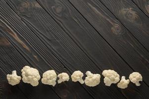 Raw, fresh organic cauliflower on a wooden background. Healthy eating, low carb diet concept photo