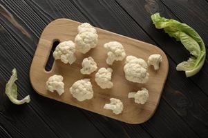 Raw, fresh organic cauliflower on a wooden background. Healthy eating, low carb diet concept photo