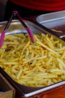 Overhead view of golden deep fried French fries food in full frame closeup. photo