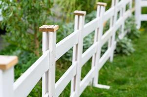 white wooden fence on the grass photo